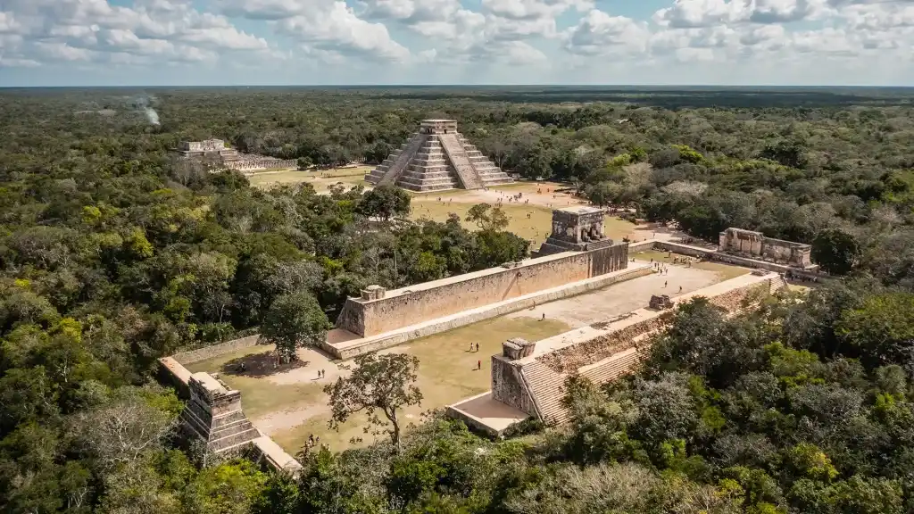 Aerial view of Chichen Itza ruins, showcasing the Kukulcan pyramid and the Great Ball Court.