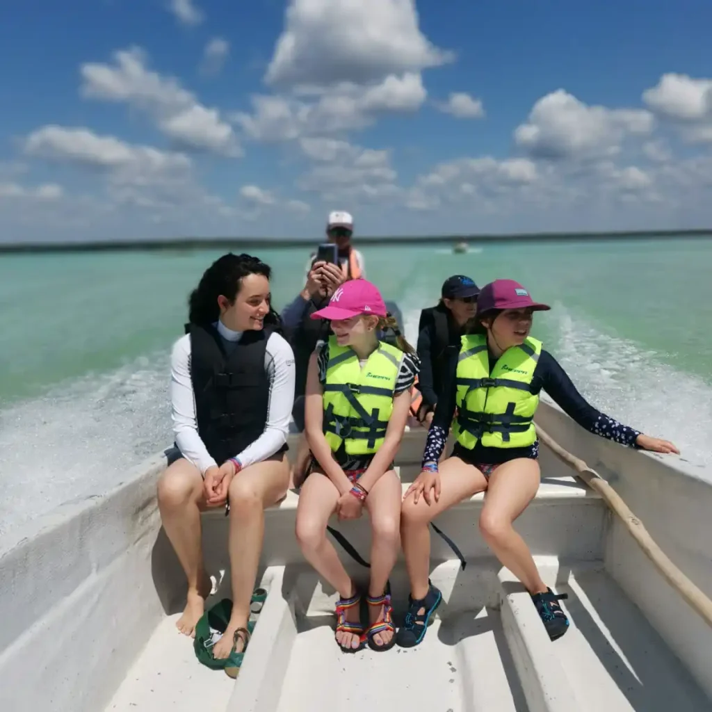 Family enjoying a private boat tour through the serene Muyil floating rivers in Tulum.