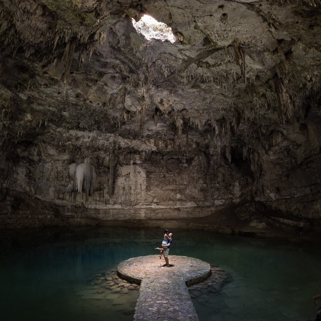 A couple embracing inside Suytun cenote, one of the cenotes featured in the Yucatan private tour.