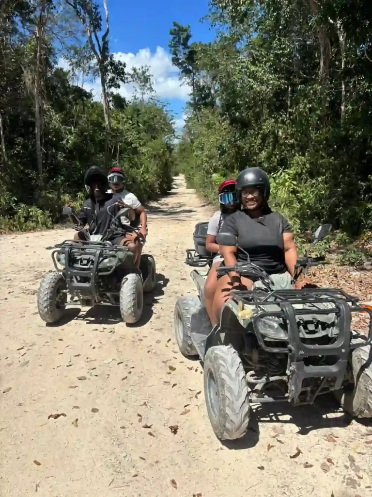 Group of four riding ATVs on a jungle trail near Tulum