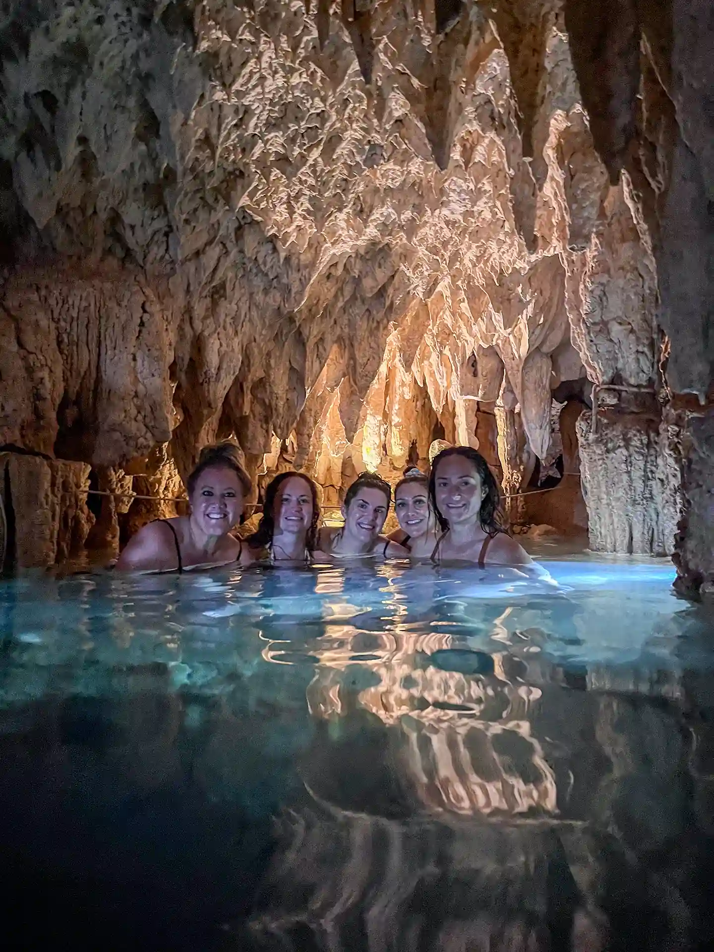 Bachelorette group enjoying a swim in a cenote cave near Tulum.