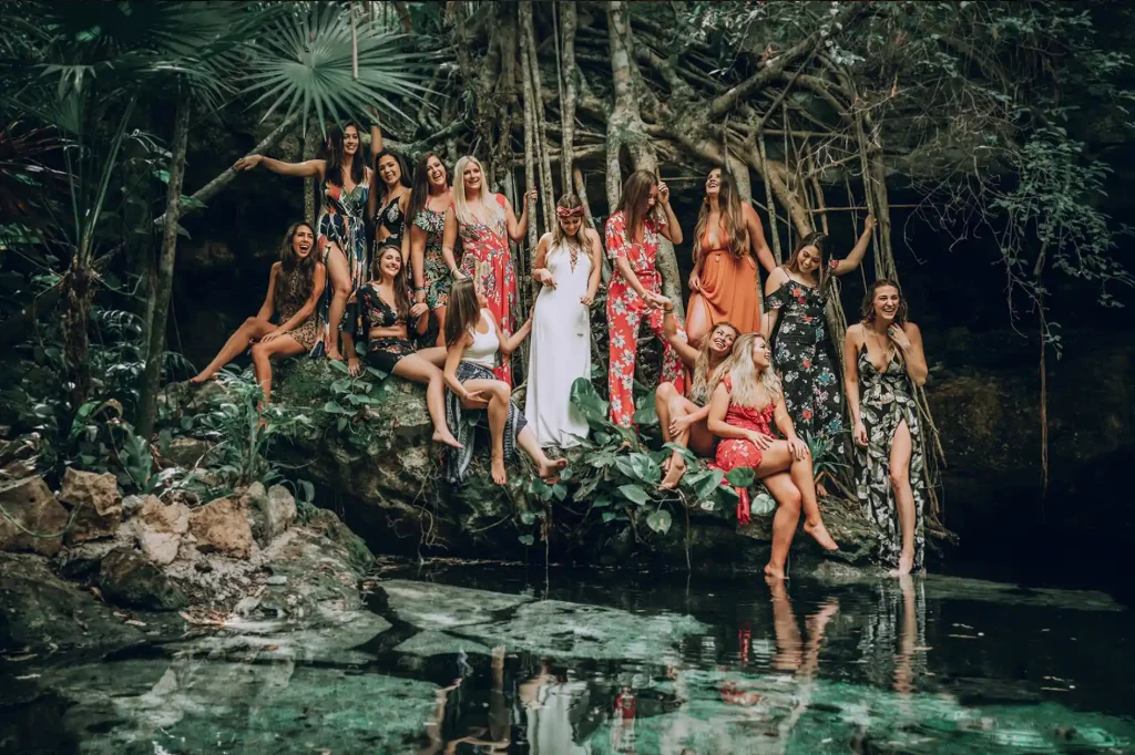 Women joyfully celebrating at a crystal-clear water Tulum cenote