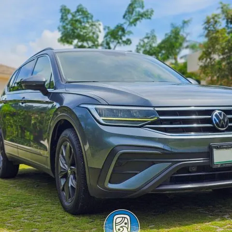 Private Volkswagen Tiguan transfer parked in the grass.