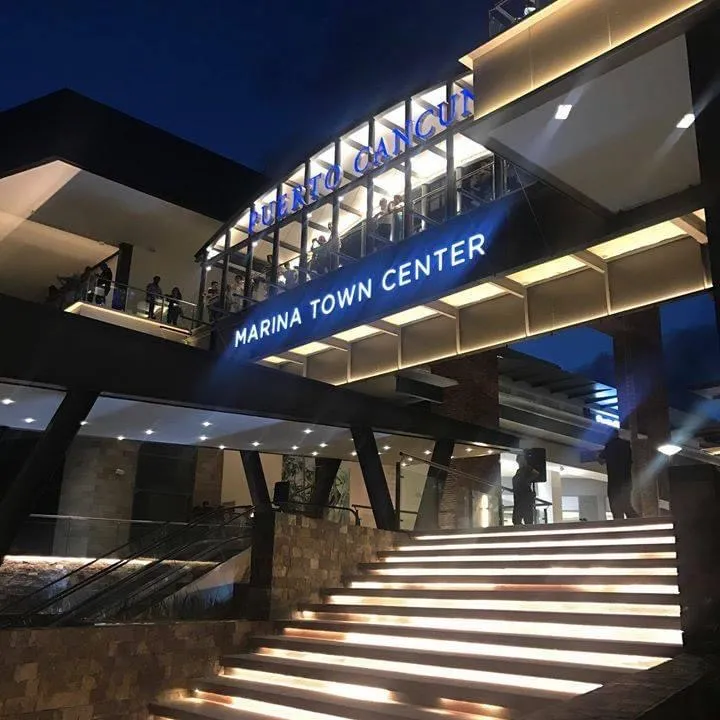 Entrance to the Puerto Cancun luxury mall with modern architecture and elegant design.