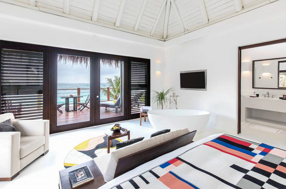 Tulum luxury hotel boutique room with ocean view, modern decor, freestanding bathtub, and private terrace.