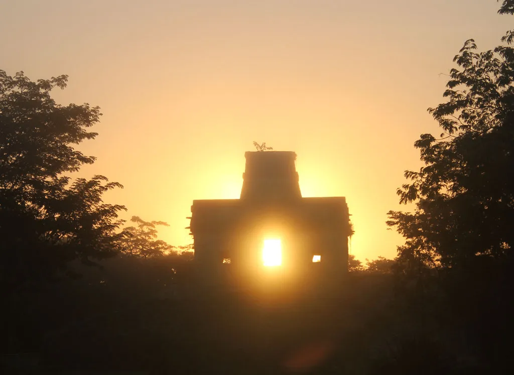The phenomenon of the spring equinox showing the sun silhouette between a temple.
