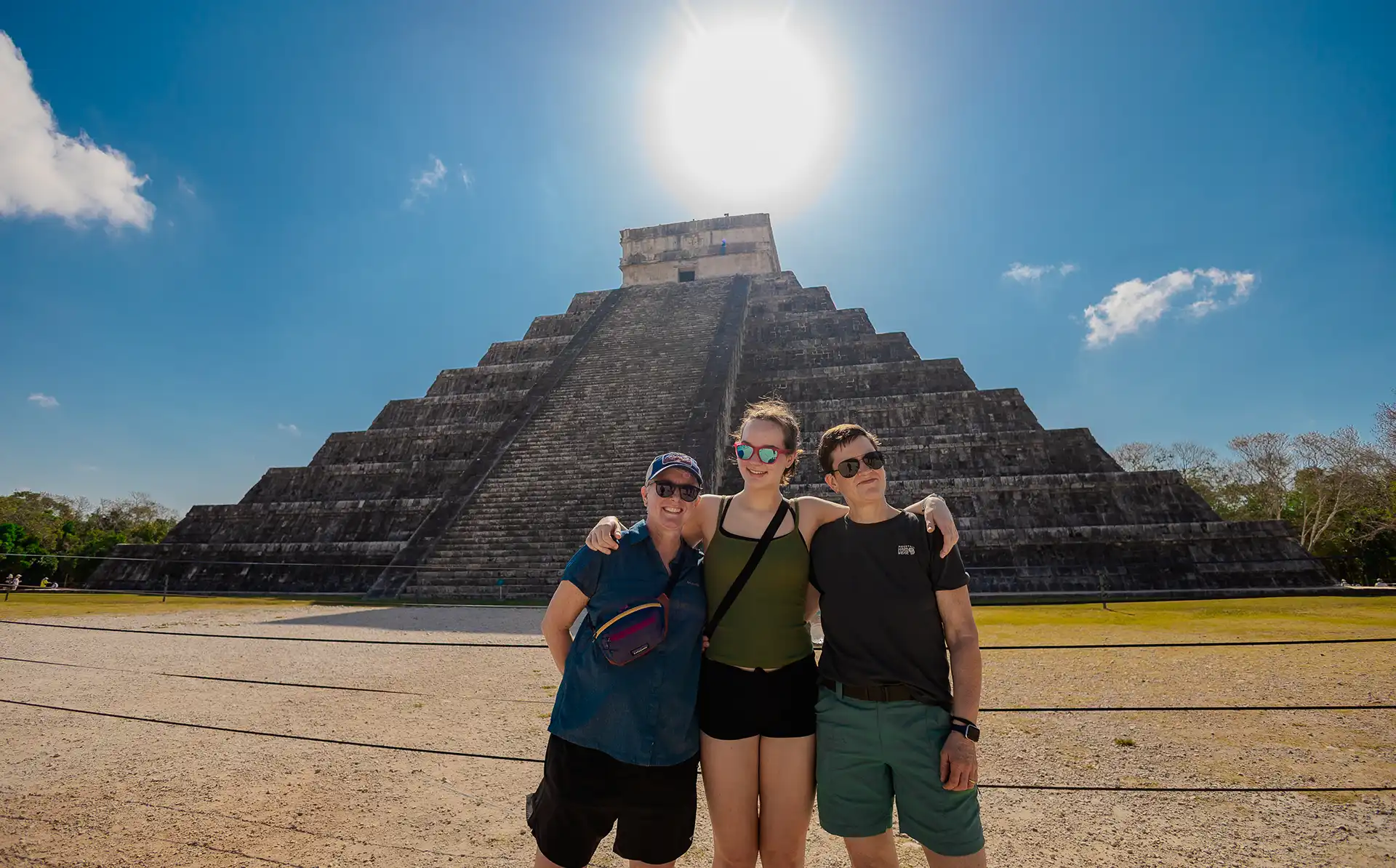 Tourists pose in front of the El Castillo pyramid at Chichen Itza.