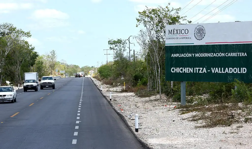 Highway with road sign indicating the route from Chichen Itza to Valladolid in Mexico