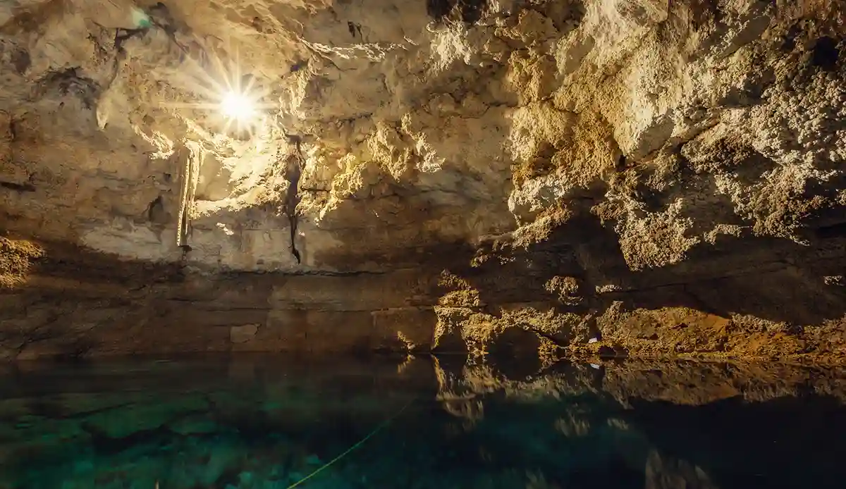 Sunlight shining into Cenote Tankach-Ha cave near Coba.