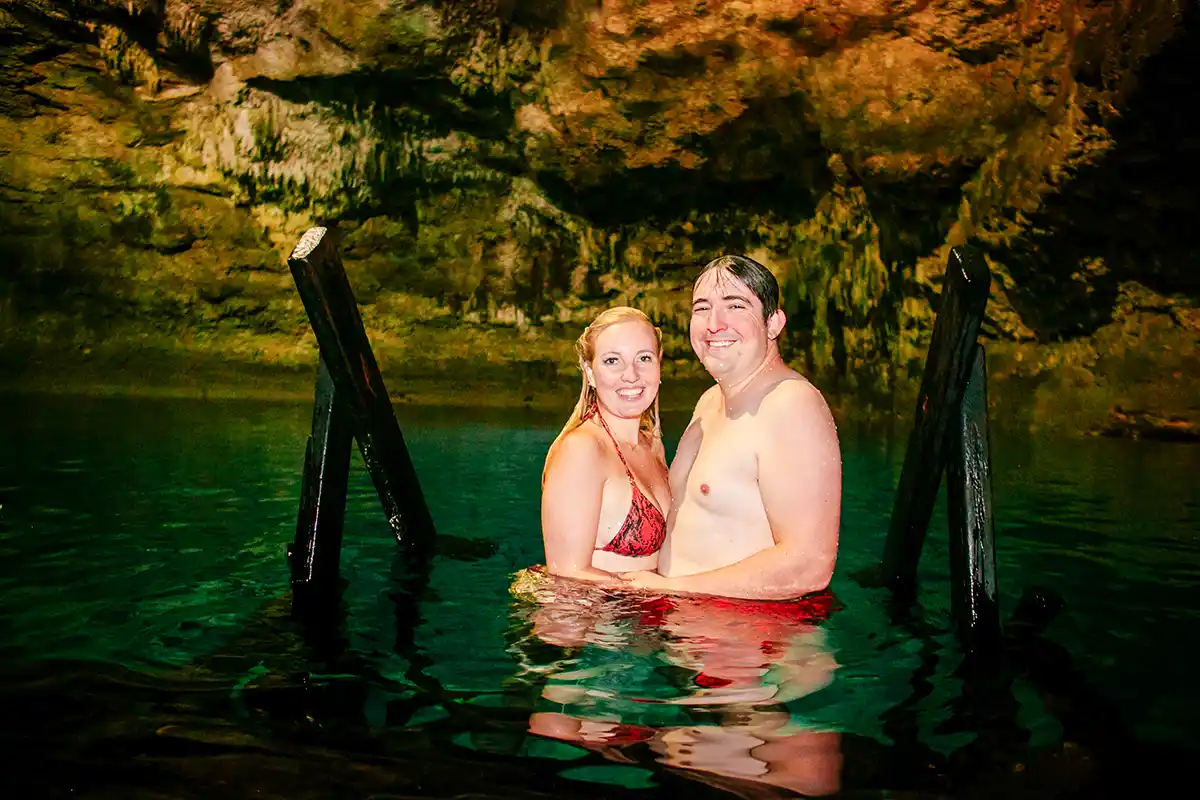Couple swimming in Cenote Tankach-Ha near Coba.
