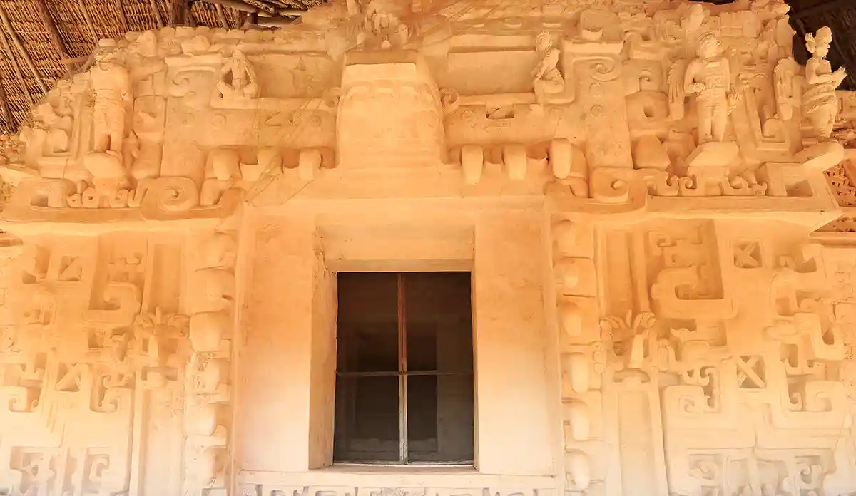 Detailed Mayan stucco wall carvings featuring intricate patterns