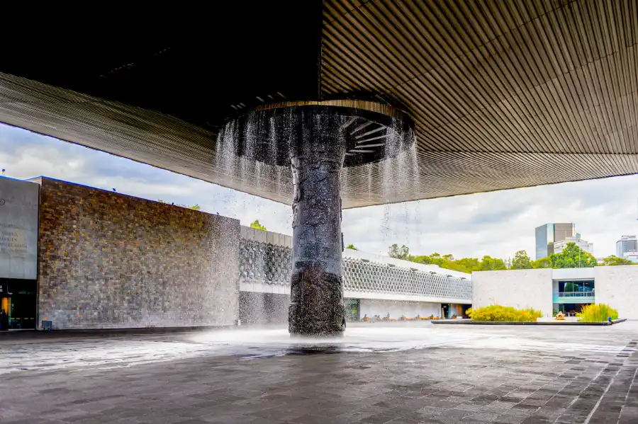 Courtyard with iconic waterfall pillar at the National Museum of Anthropology in Mexico City.