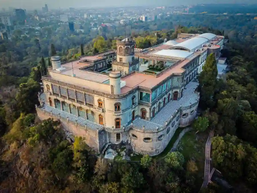 Lateral aerial view of Chapultepec Castle built on a hilltop, surrounded by the forest of Chapultepec and overlooking Mexico City.