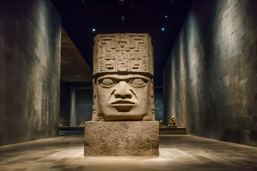 Massive Olmec head sculpture inside the National Museum of Anthropology in Mexico City.