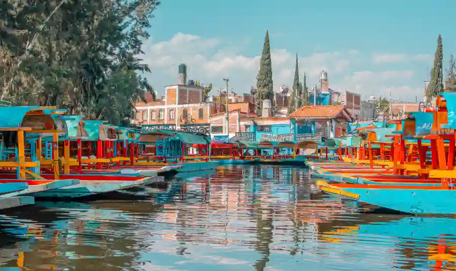 Colorful trajineras docked along the canals of Xochimilco in Mexico City.