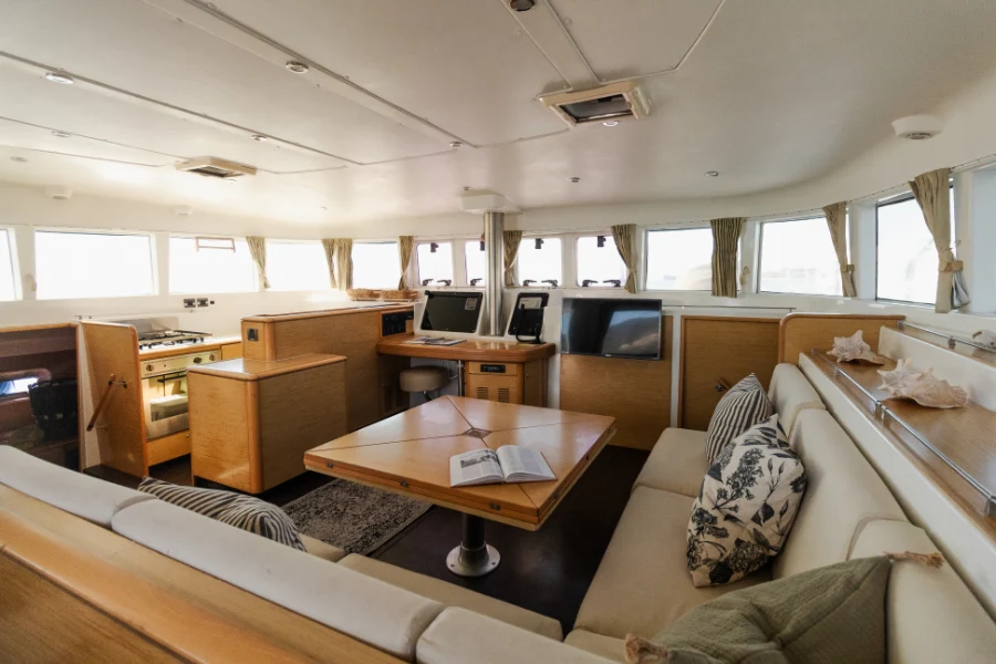 Interior lounge and dining area of a 51 foot Lagoon catamaran during a private catamaran Cabo San Lucas sailing tour.