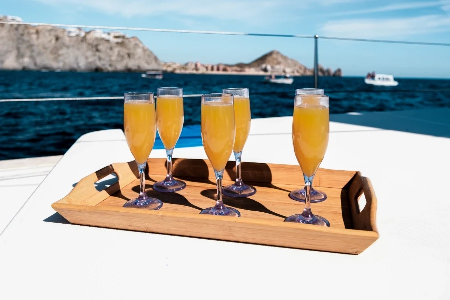 Champagne drinks served on deck during a private catamaran Cabo San Lucas sailing tour near Land’s End.