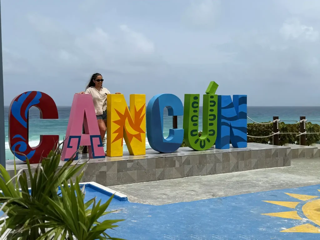 Cancun sign with tourists posing for photos in the hotel zone
