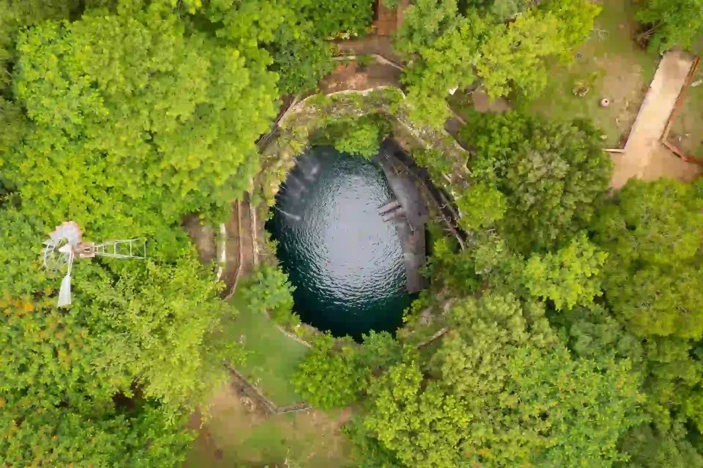 Aerial view of Cenote Saamal with blue waters in Yucatan, Mexico