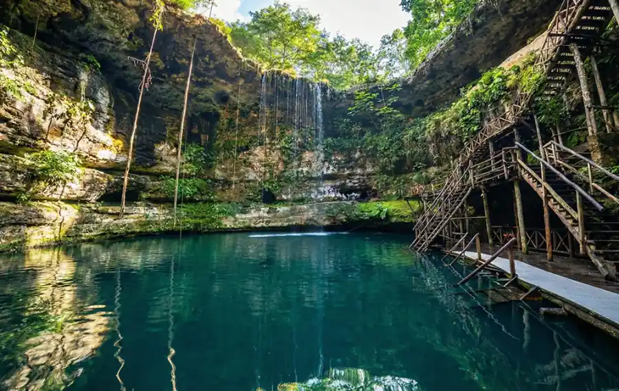 Cenote Saamal with stalactites and turquoise waters inside underground cave