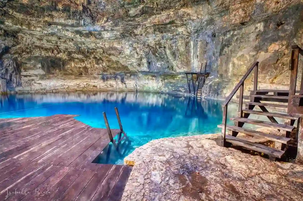 Entrance platform of Cenote Xux Ha surrounded by tropical vegetation