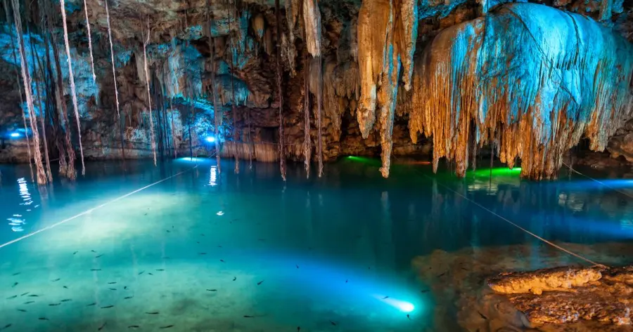 Cenote Xux Ha with waterfall and wooden platform in Yucatan, Mexico