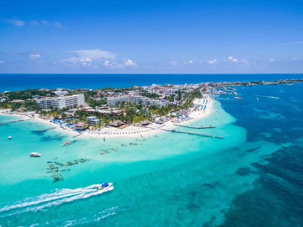Wide aerial drone view of Isla Mujeres island surrounded by crystal-clear turquoise water