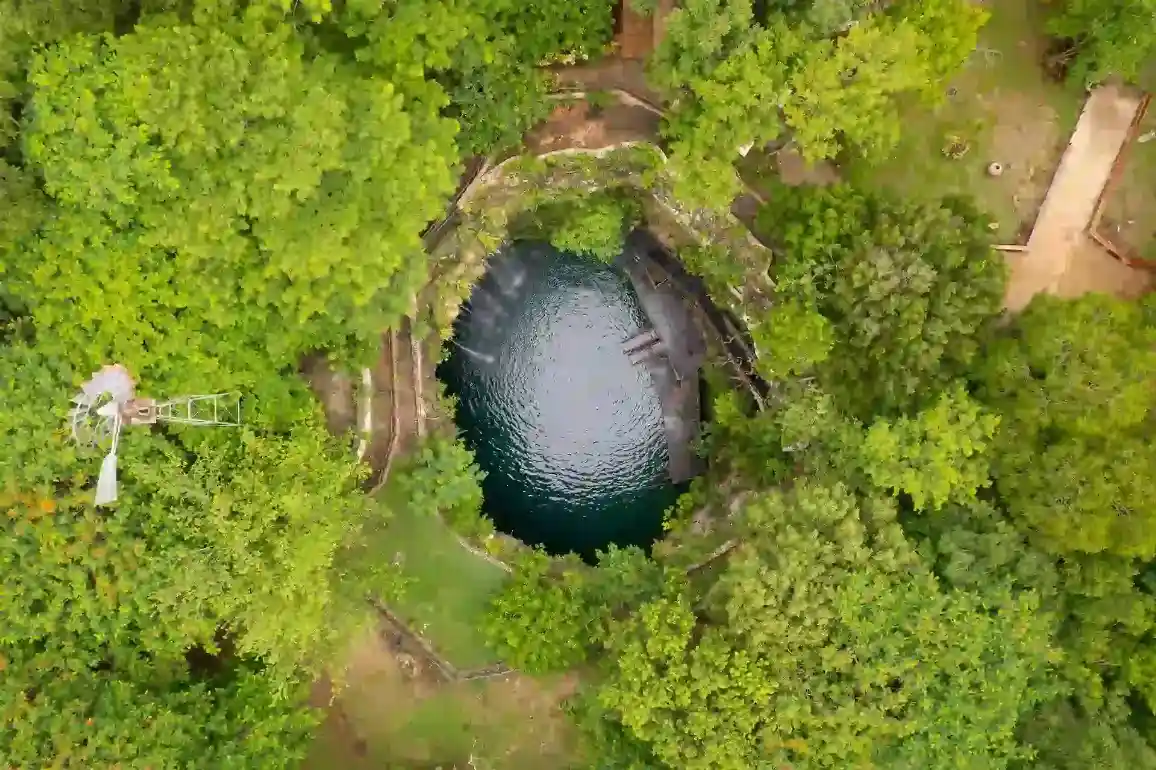 Aerial view of Cenote Saamal with blue waters in Yucatan, Mexico
