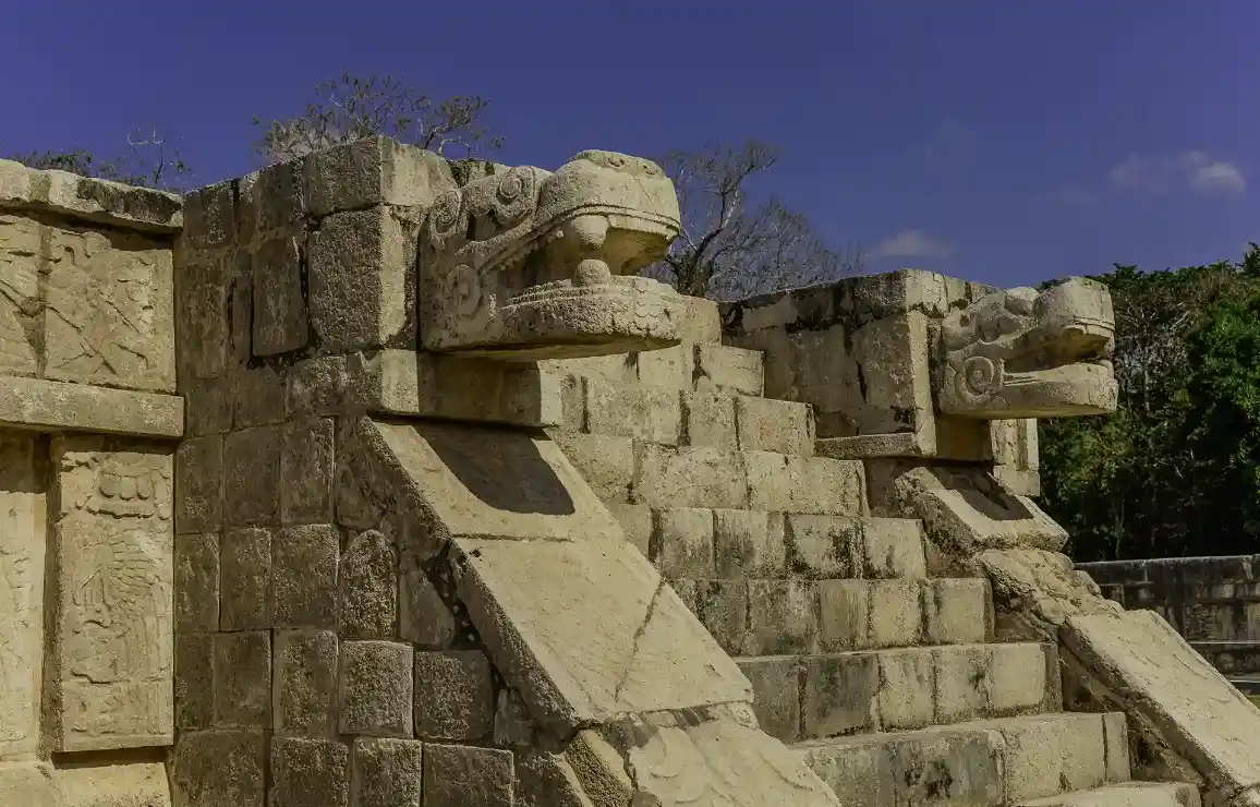 Stone serpent head sculptures at the Temple of Kukulkan in Chichen Itza.