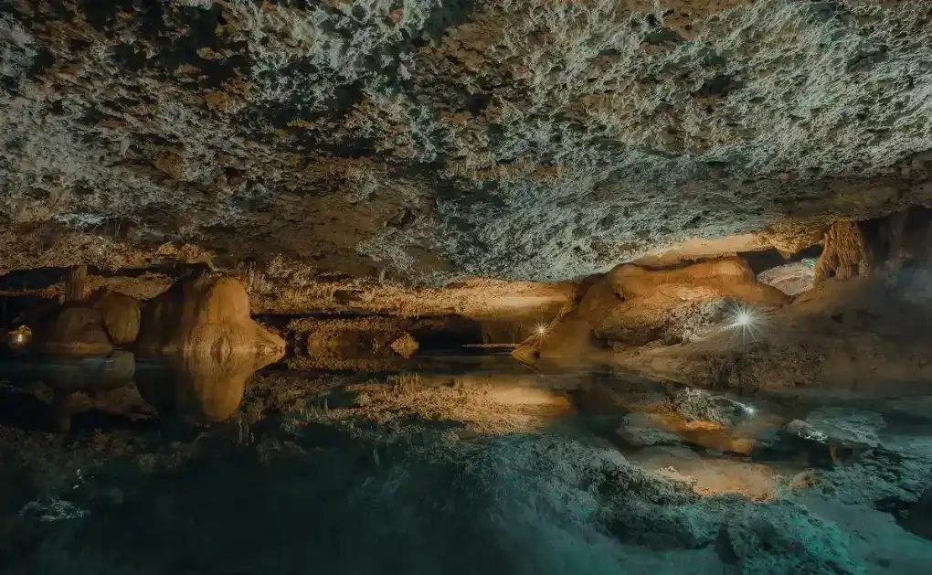 Private underground cenote with stunning rock formations and clear water.
