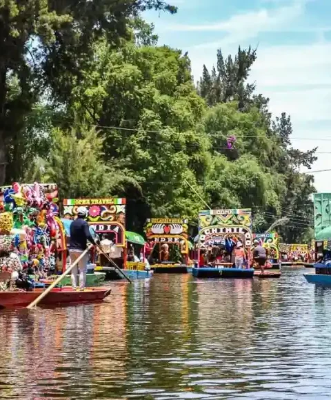 Various trajineras sailing through the canals of Xochimilco.