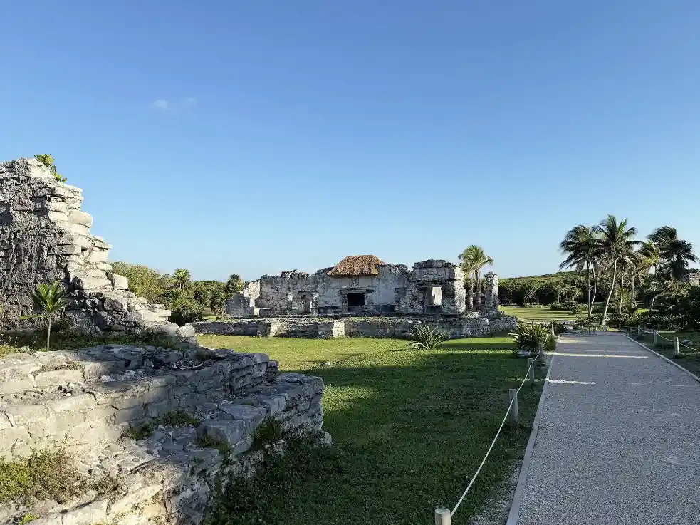 Ancient Mayan ruins at Tulum with a stone pathway through greenery